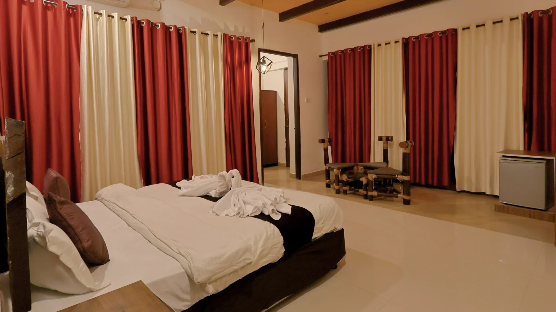 Super Deluxe Room with luxurious bed at Wildmark Kanha Resort