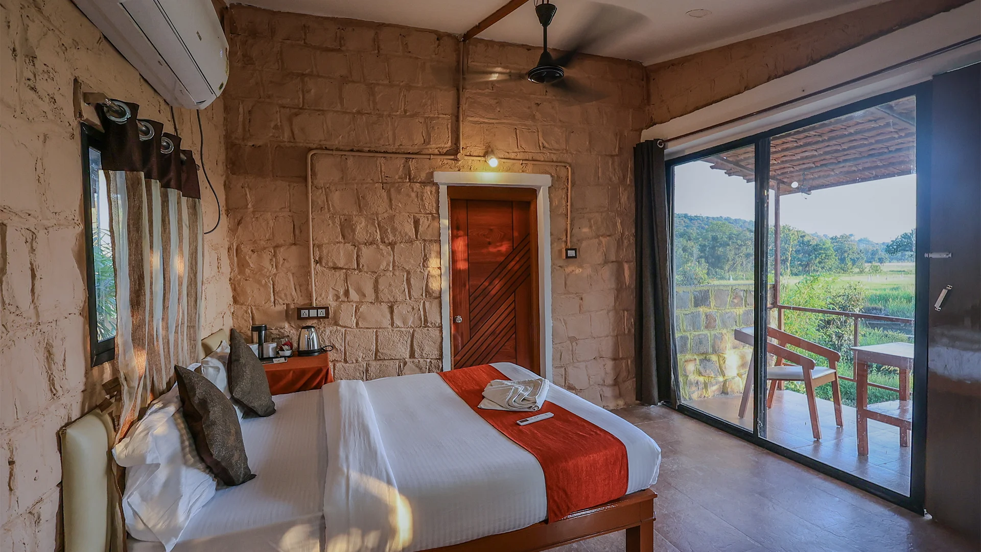 "Luxury Machaan Cottage featuring a king-size bed and private balcony at Tadoba