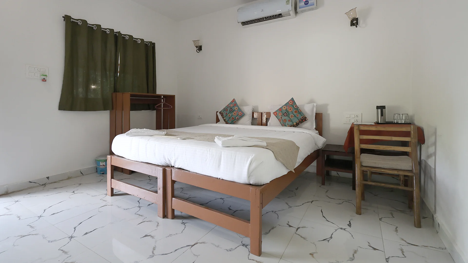 Air-conditioned individual cottage featuring a cozy bed at Tadoba Safari Stay