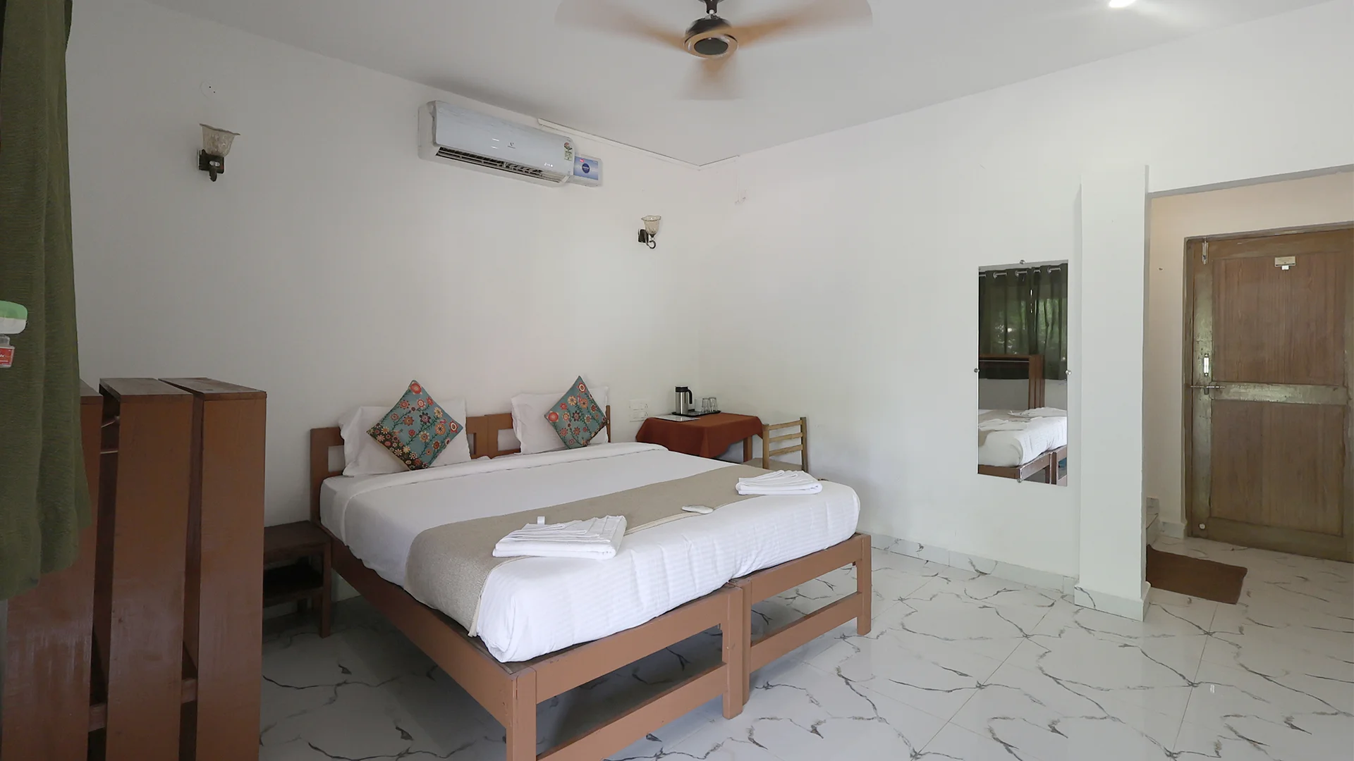 Air-conditioned individual cottage featuring a cozy bed at Tadoba Safari Stay - 2