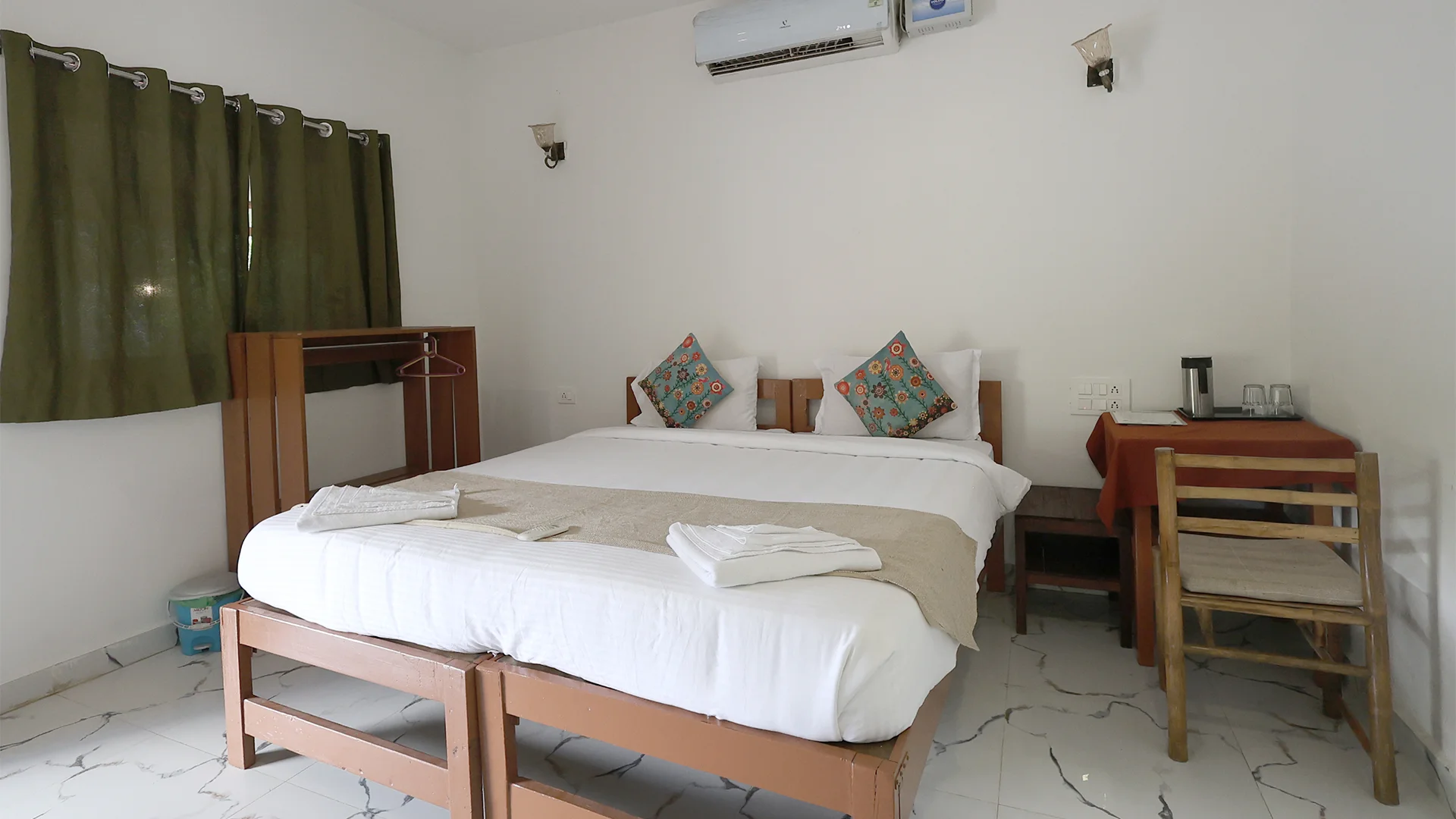 Air-conditioned individual cottage featuring a cozy bed at Tadoba Safari Stay
