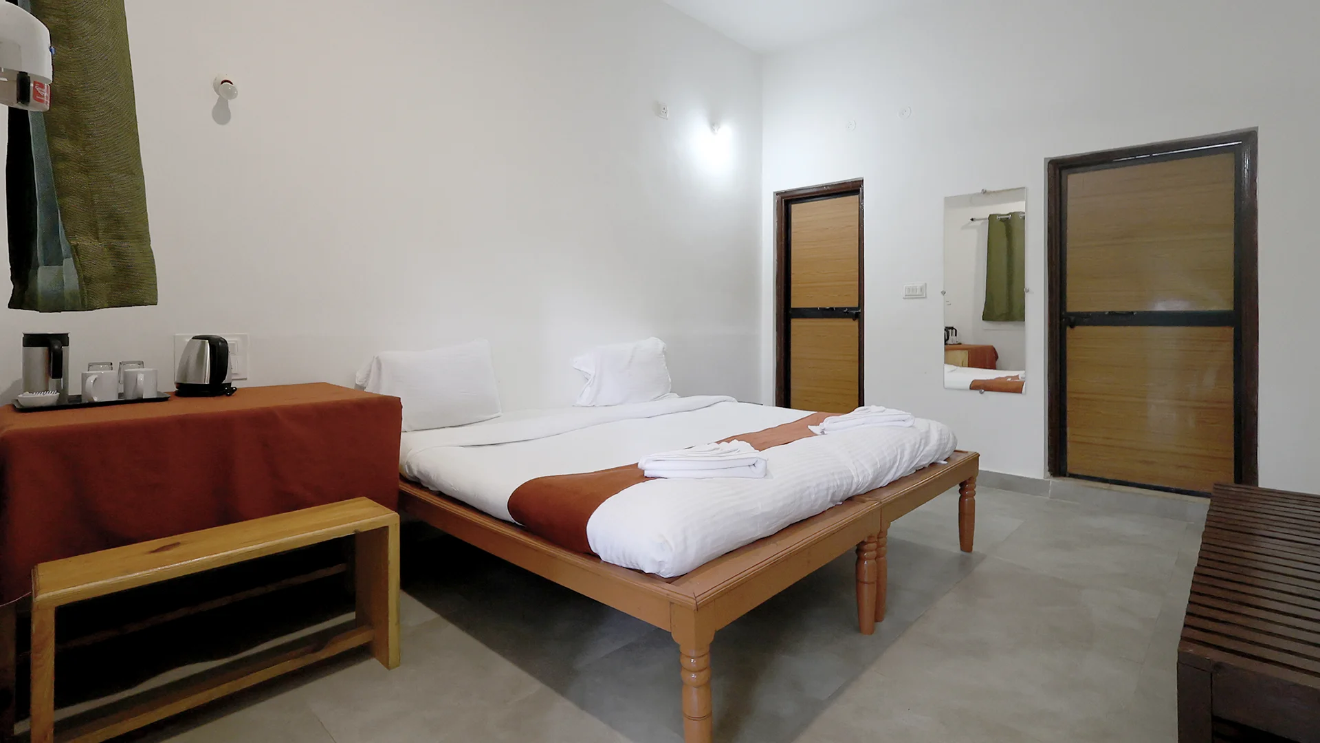 Air-conditioned Deluxe Room featuring a king-size bed at Tadoba